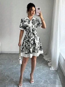 Detail of floral printed dress with button-down front and waist tie on a model