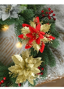 Detail of Christmas poinsettia wreath with red berries, pine needles and warm LED lights