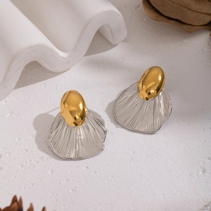 Creative geometric gold and silver leaf stud earrings with ribbed texture on art background