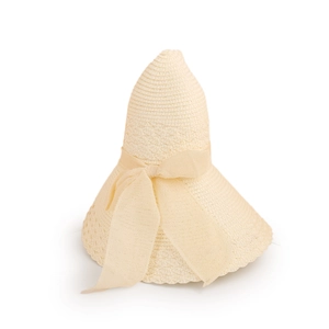 Detail of hand-woven straw hat texture with an elegant mesh bow in French vintage style