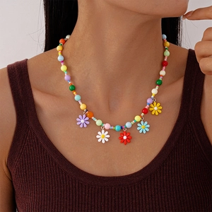 Detailed side view of a colorful acrylic daisy choker necklace worn by a model