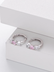 Macro view of 925 sterling silver stamp on heart-shaped pink zircon hoop earrings