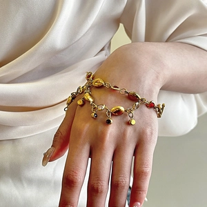 18K gold-plated titanium steel bracelet featuring colorful gemstones on a silk background