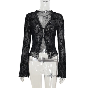 Close-up of black floral chiffon blouse with lace texture and flared ruffle sleeves