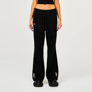 Detailed front view of black cotton flare sweatpants with white cross embroidery