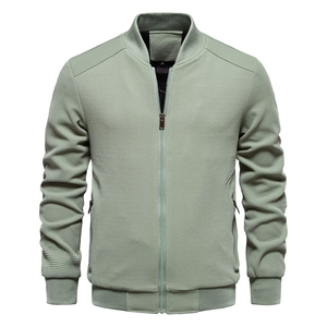 Detailed close-up of bean green waffle texture fabric on bomber jacket with ribbed collar