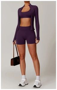 Detail of deep purple yoga jacket featuring high collar, zipper, and thumbholes