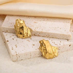 Irregular lava texture 18K gold plated stainless steel earrings on a stone base
