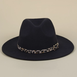 Close-up of black felt fedora hat featuring leopard print band and gold buckle detail