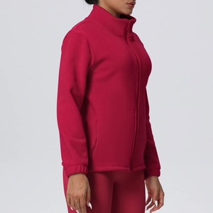 Detail view of red fleece jacket featuring high collar design and smooth zipper closure