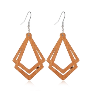 Detailed view of hollow geometric diamond wood earrings with metallic hooks on white base