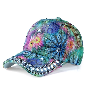 Detailed view of large rhinestones and colorful floral print on the baseball cap side