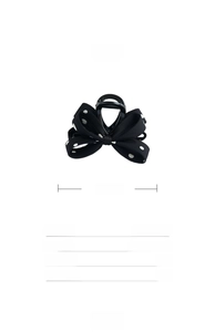 Vue détaillée d'une pince à cheveux de 10cm avec nœud en tissu à pois rétro noir