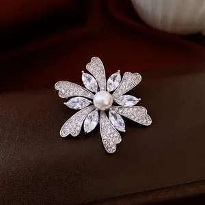 Luxury floral brooch with sparkling cubic zirconia and pearl on elegant silk background