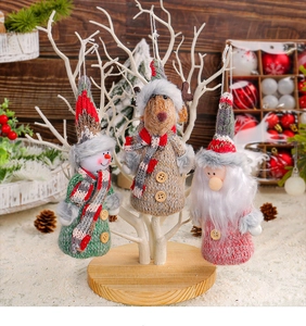 Detail of Christmas knitted ornaments featuring Santa, snowman, and reindeer figures