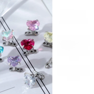 Macro detail of heart-shaped zircon dermal piercings in various vibrant colors