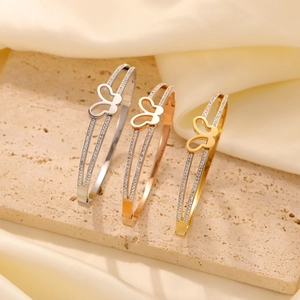 Detailed shot of butterfly openwork bracelets in silver, rose gold, and gold finishes