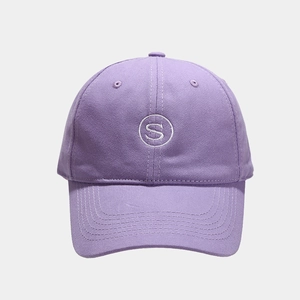 Close-up of white S-letter embroidery on purple cotton canvas baseball cap