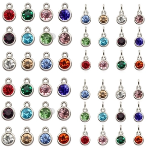 Macro view of multi-colored rhinestone birthstone pendants in silver metal settings