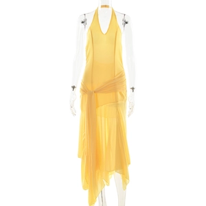 Detail of yellow halter neck chiffon dress with waist tie and asymmetrical hemline