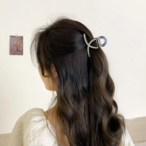 Minimalist striped silver hair claw clip for women, medium size shown in a half-up hairstyle