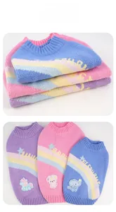 Detail of soft knitted pet sweaters with rainbow stripes and cute cartoon embroidery patches