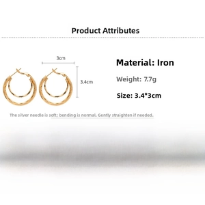 Detailed specs of geometric double-layered golden hoop earrings with silver needles