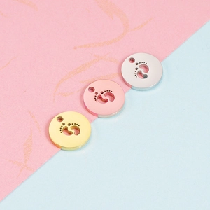 Polished stainless steel round pendants with baby footprint cutout in three metallic colors