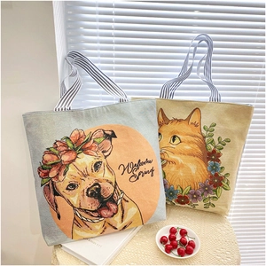 Detail of floral animal canvas tote bags with cat and dog embroidery and striped handles