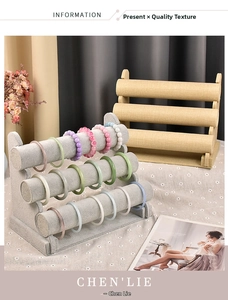 Three-tier velvet jewelry display stand for bracelets and watches in a cozy home setting