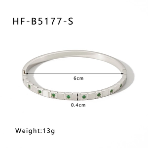 Detail view of silver stainless steel bangle with green zircon inlay and 6cm diameter