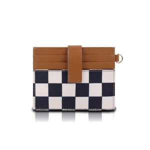 Macro detail of brown leather and checkerboard canvas RFID card holder with D-ring