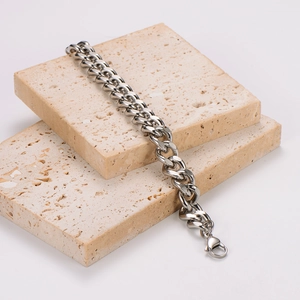 Polished silver stainless steel Cuban link bracelet for men on stone display