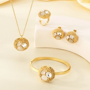 Detailed view of luxury gold-plated jewelry set with round opal and zircon stone inlay
