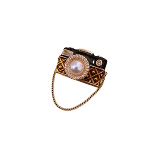Vintage camera brooch with black enamel, large pearl lens and sparkling zircon details