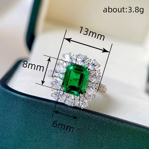 French court style ring with emerald green stone and small diamonds in jewelry box