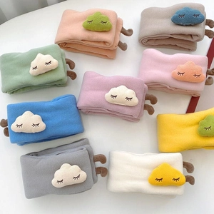 Detail of soft knitted baby scarves in eight colors with cute cloud embroidery patches