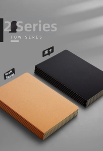 Detail view of stacked B5 kraft and black cardstock notebooks with sewn binding texture