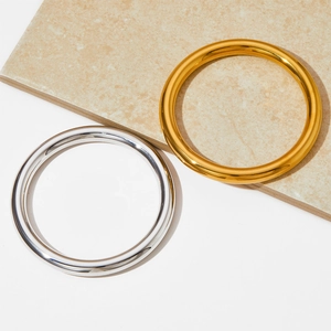 Minimalist stainless steel hollow bangles in gold and silver finish with polished surface