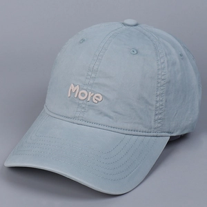 Close-up of pink 3D embroidered More lettering on light blue washed cotton baseball cap
