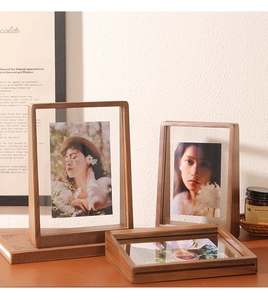 Detail of a walnut wood floating frame showing the natural grain and glass panel