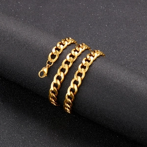 Close-up of golden stainless steel Cuban link chain necklace with lobster clasp on black background