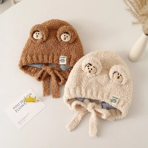 Plush baby winter hat with bear ears and chin straps in brown and beige colors