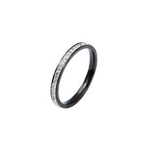Close-up detail of a minimalist black titanium steel ring with a single row of rhinestones