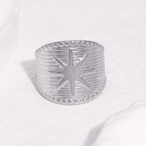 Polished silver stainless steel wide open ring featuring a celestial starburst relief