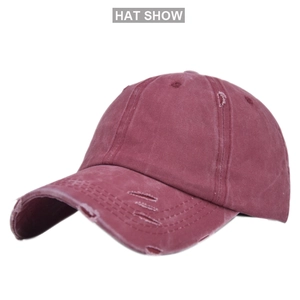 Detail of vintage burgundy ponytail baseball cap with distressed torn fabric and wash finish