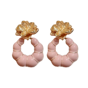 Vintage style gold flower earrings with pink circular pendants in a high-gloss finish