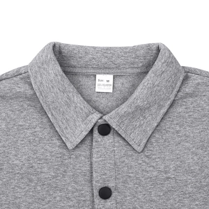 Detail of grey outdoor jacket collar showing fabric texture and 100% polyester label