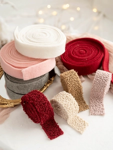Detail of wool felt and faux fur Christmas ribbons in various colors for DIY crafts