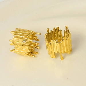 Detailed macro view of gold-tone minimalist molten lava style open adjustable rings